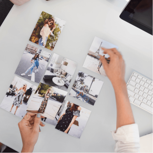 Stylish influencer photography, including women's fashion and lifestyle imagery, arranged as a mood board on a white desk
