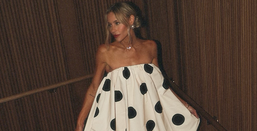 Creator in white puffy dress with large black polka dots