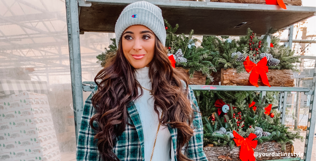 Influencer yourdarlingstyle standing in front of shelves full of holiday decor