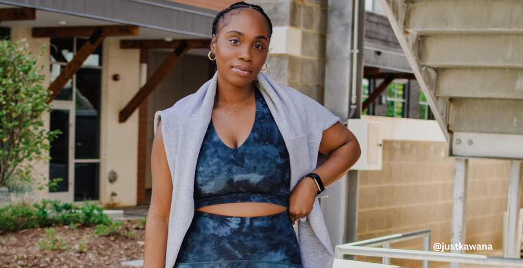 Content Creator @justkawana posing for a photo in a two-toned blue activewear set before her workout session.