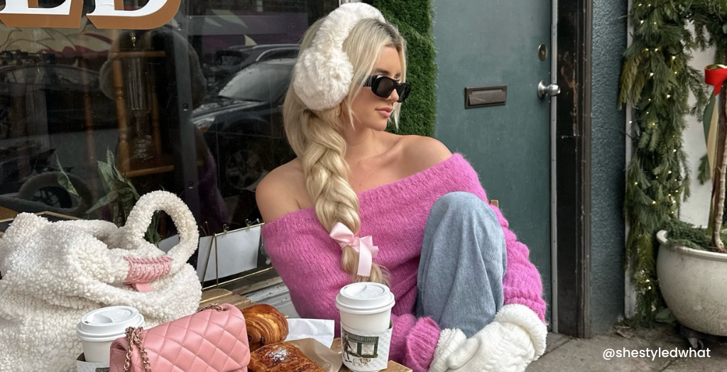 Creator @shestyledwhat sitting outside a coffee shop eating croissants